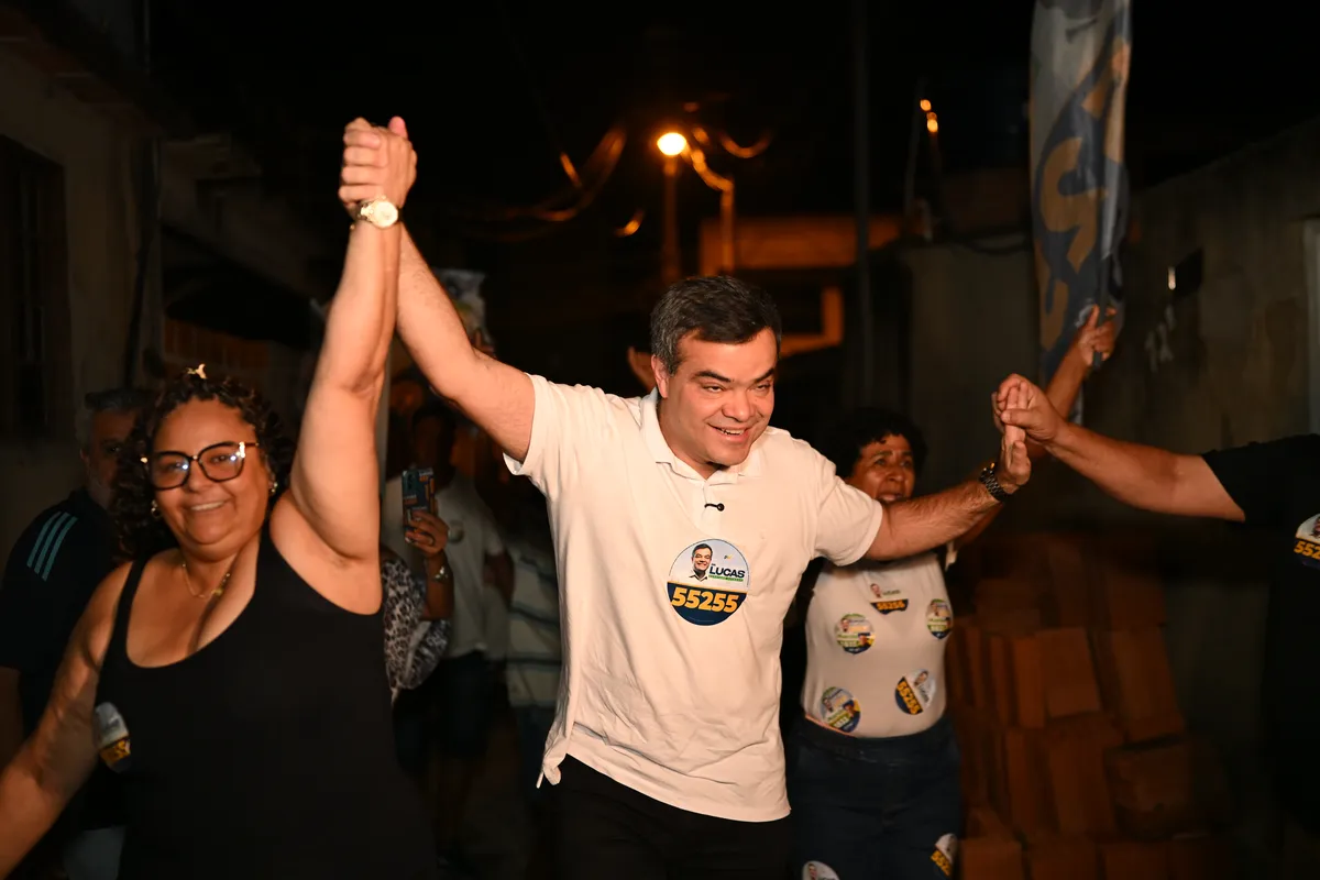 Dr. Lucas 55255 de braços erguidos com apoiadoras na rua, em Lagomar